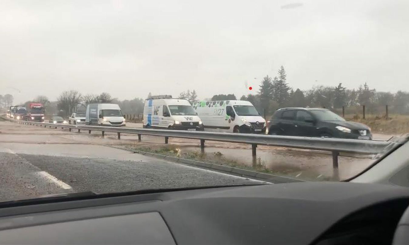 Drivers on the A90 at Laurencekirk crawl through floods as road